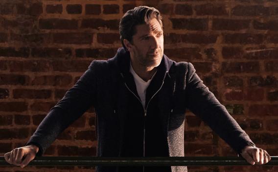 NHL Hall-of-Famer Henrik Lundqvist standing at a railing.